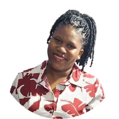 Smiling woman with braided hair wearing a white shirt with large red leaf patterns.