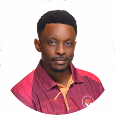 Portrait of a man with short curly hair wearing a maroon and pink collared shirt.